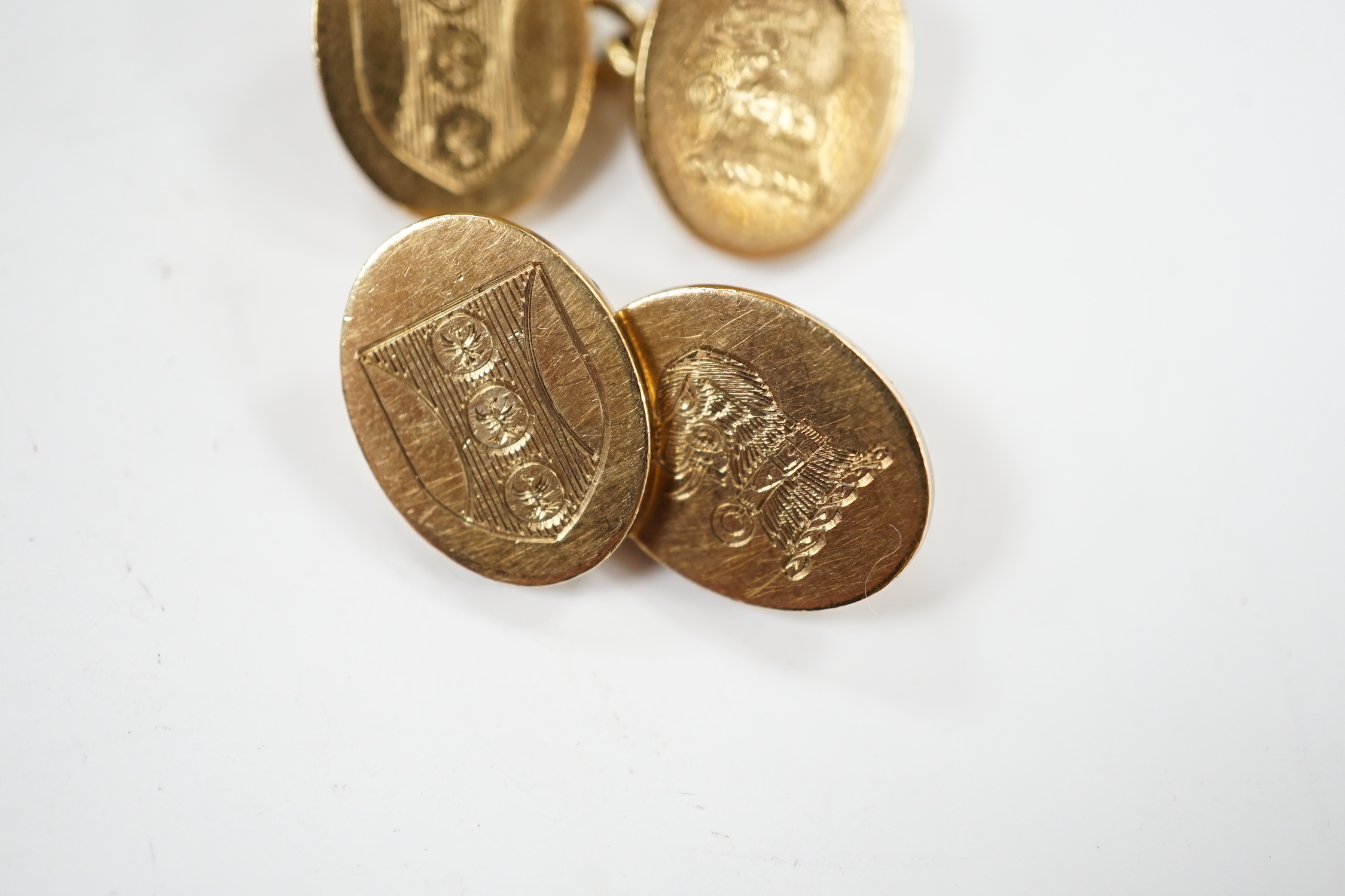 A pair of early 1960's 9ct gold oval cufflinks, with engraved crest and monogram, 10.3 grams.